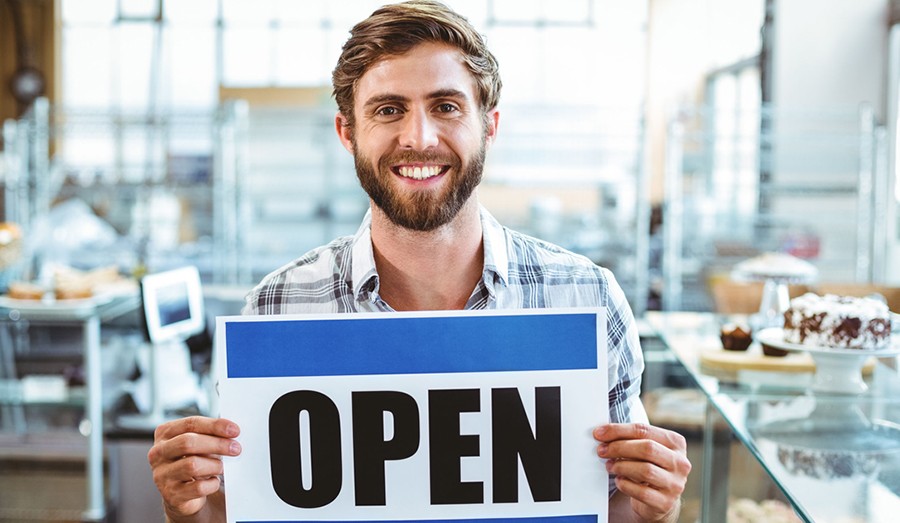 business owner holding open sign