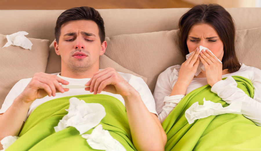 couple sick in bed with flu